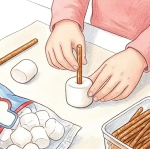 Gently push a pretzel stick into the middle of a marshmallow. That's… – Chocolate Marshmallow Dreidels – Recipe for kids