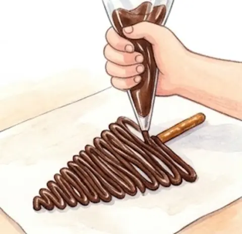 Pipe chocolate straight onto the stick, in lines going back and forth… – Chocolate Pretzel Christmas Trees – Recipe for kids